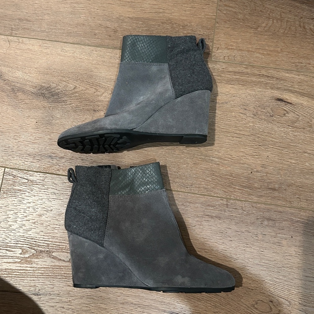 Gray booties with felt like detail at heel